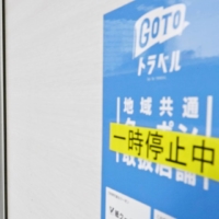 A Go To Travel campaign poster at Nagoya Station in December says the campaign was suspended. JTB Corp. will reduce its capital to ¥100 million, making it eligible to gain a tax advantage at a time when it is facing a severe business environment due to the sharp pandemic-induced decline in travel demand. | KYODO
