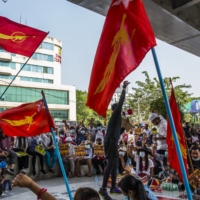 A protester speaks to a group gathered to demonstrate against the military coup, in Yangon, Myanmar, on Tuesday.  | THE NEW YORK TIMES