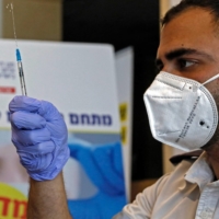 A paramedic prepares a dose of the Pfizer-BioNtech COVID-19 vaccine in Beit Shemesh, Israel, on Monday. | AFP-JIJI