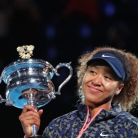 Naomi Osaka celebrates with the trophy after winning the Australian Open in Melbourne on Feb. 20. | REUTERS