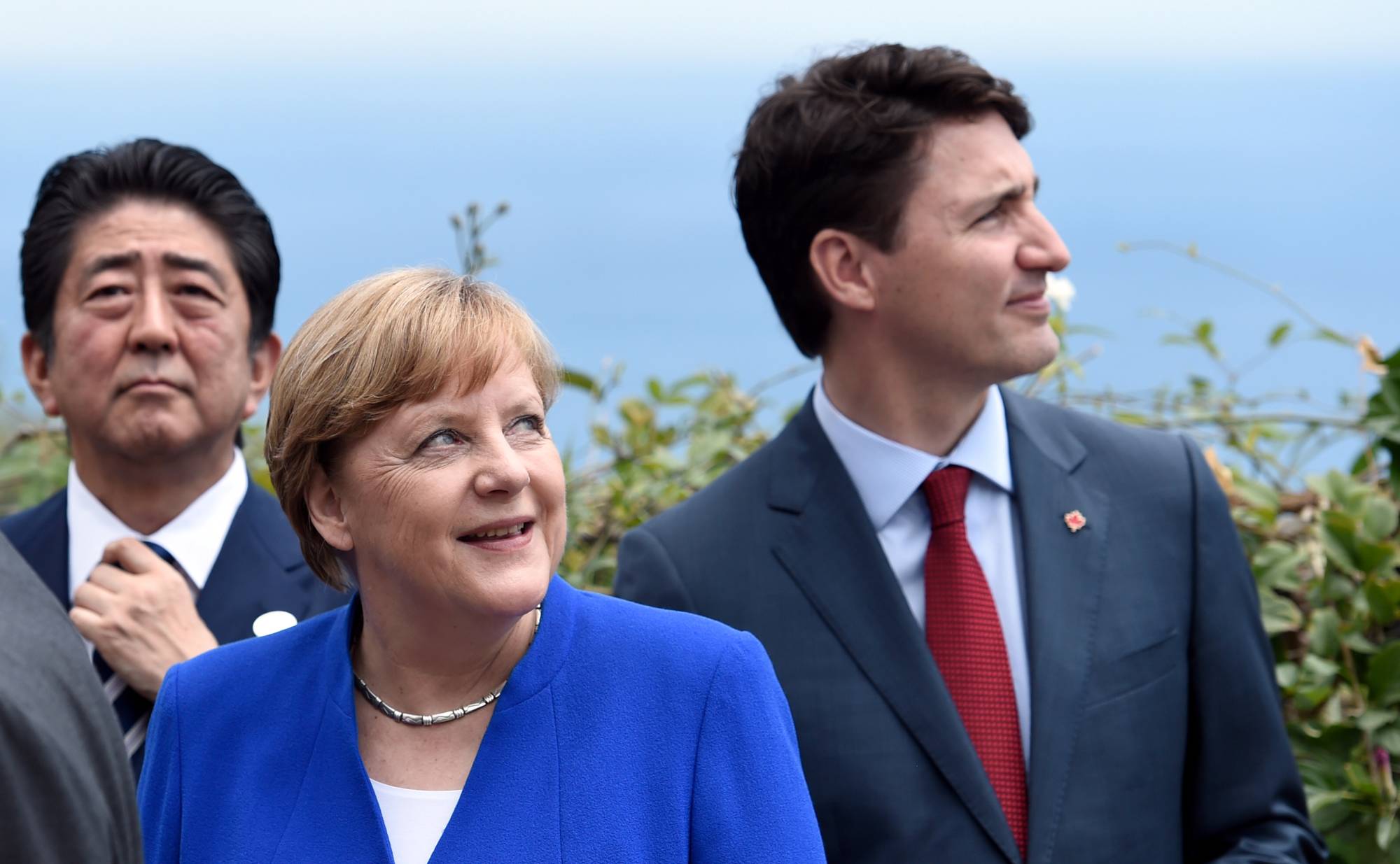 Then-Japanese Prime Minister Shinzo Abe, German Chancellor Angela Merkel (center) and Canadian Prime Minister Justin Trudeau attend the G7 Summit in Taormina, Sicily, in May 2017.   | REUTERS