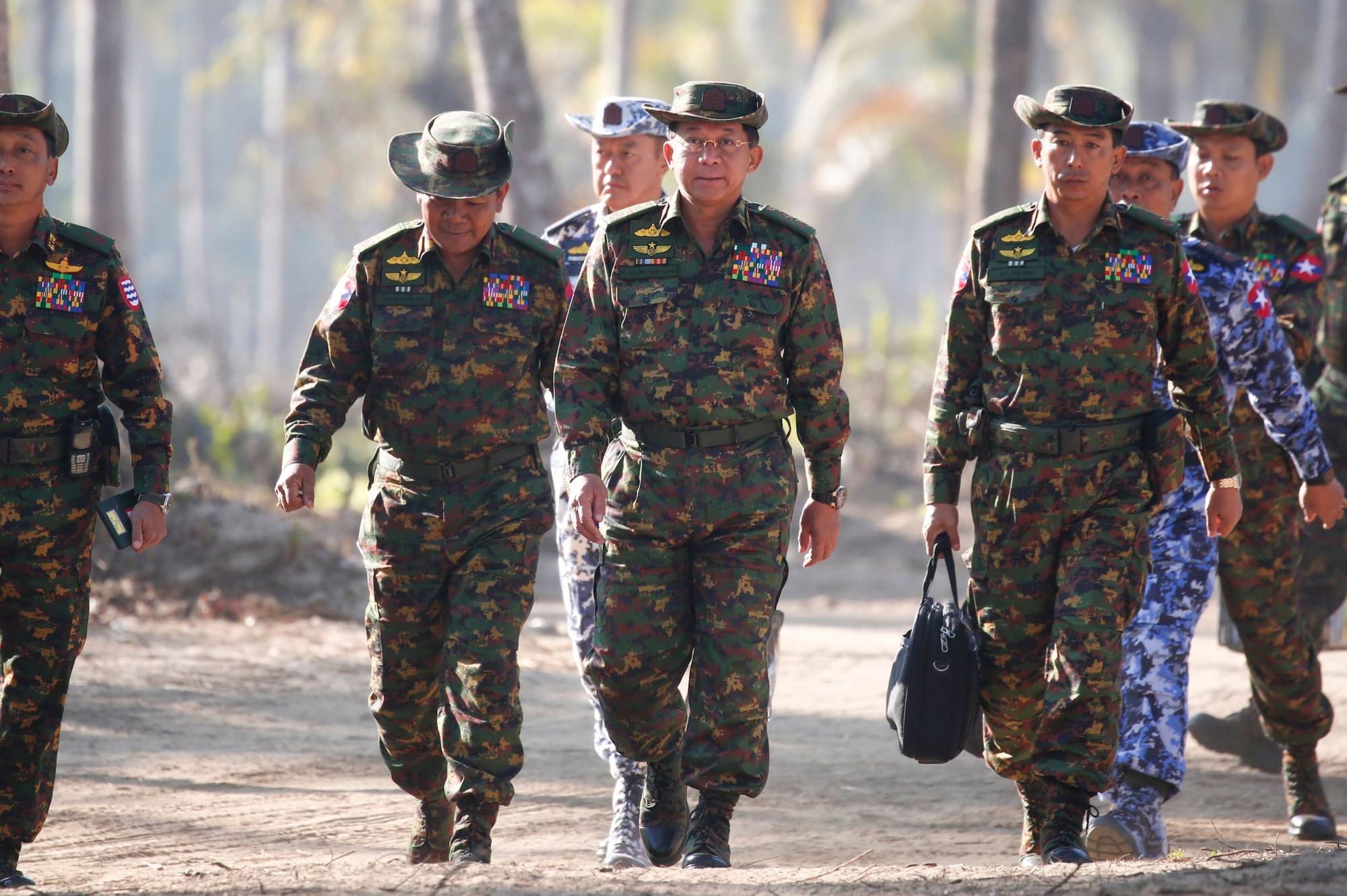 Myanmar military commander Gen. Min Aung Hlaing (center) and senior commanders arrive for joint exercises in the Irrawaddy Delta region in 2018. | POOL / VIA AFP-JIJI