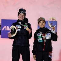 Slovenian winner Ema Klinec (center), Norwegian runner-up Maren Lundby (left) and third-place finisher Sara Takanashi celebrate on the podium of the women\'s ski jump normal hill event at the Nordic World Ski Championships on Thursday in Oberstdorf, Germany. | AFP-JIJI