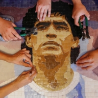 Members of Comado Maradona prepare a mosaic feature soccer legend Diego Maradona at their workshop in Buenos Aires, on Feb. 24. | REUTERS