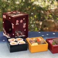Packed with memories: Children in Tokushima Prefecture often brought their lunches in yusanbako, three-tiered lacquered wooden boxes, when they went on picnics pre-World War II. | YUSANBAKO CULTURAL PRESERVATION SOCIETY
