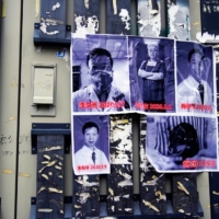 Posters in memory of late doctor Li Wenliang and other doctors are seen on a street near the Central Hospital in Wuhan, China, on the anniversary of Li\'s death on Feb. 7. | REUTERS