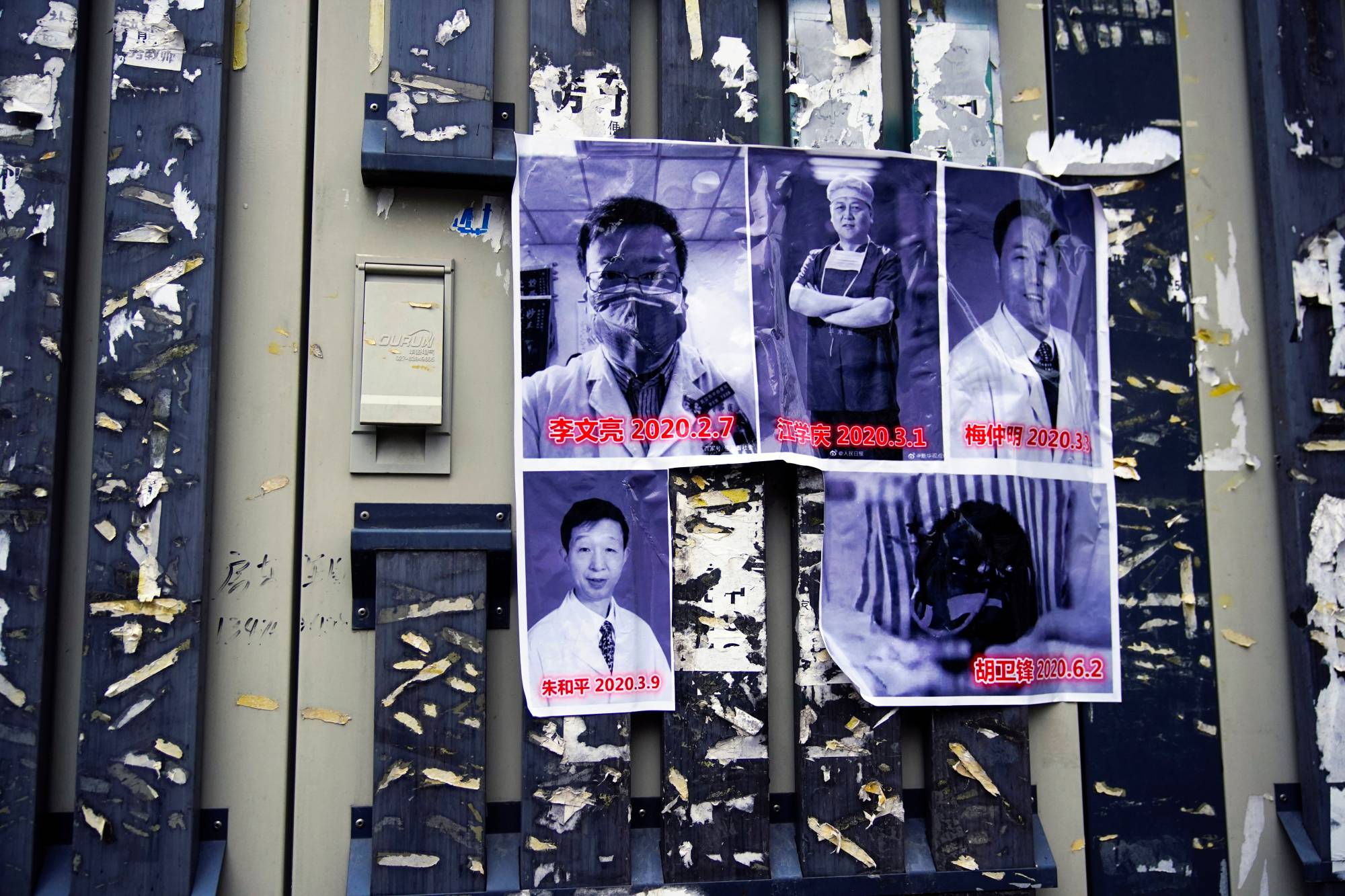 Posters in memory of late doctor Li Wenliang and other doctors are seen on a street near the Central Hospital in Wuhan, China, on the anniversary of Li's death on Feb. 7. | REUTERS