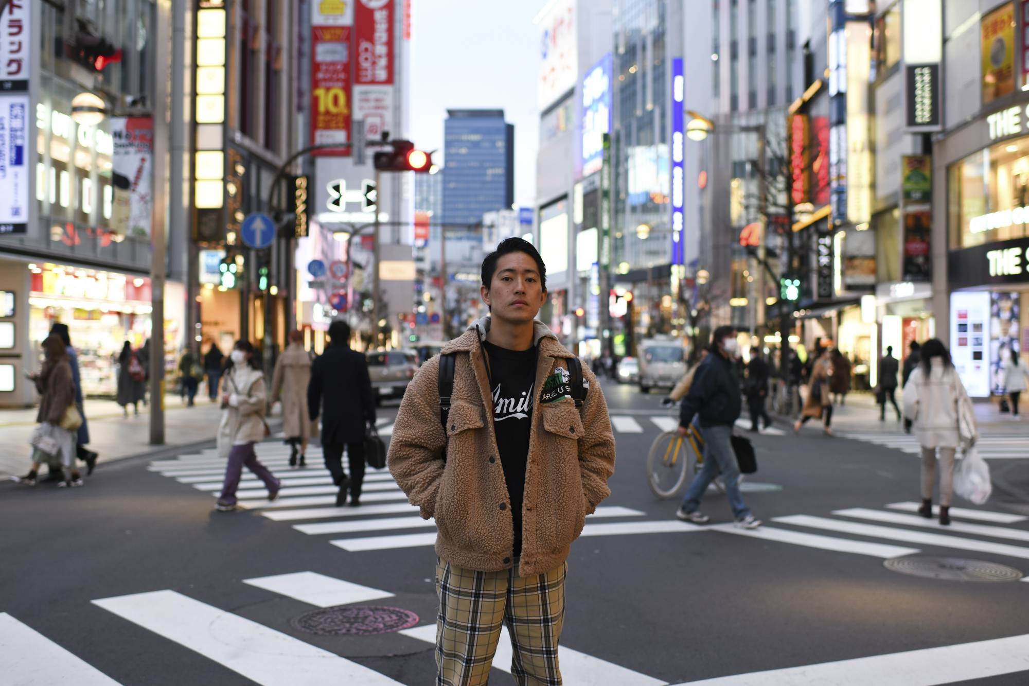 Kaisei Sugawara, an engineer at one of Japan’s largest security companies, in Tokyo's Shinjuku district, on Friday. Some young workers say they are seeing signs of cracks in Japan's rigid culture of seniority, even in more traditional companies; Sugawara expects to be posted abroad by his fourth year, far earlier than in previous generations. | Noriko Hayashi/The New York Times