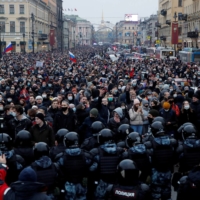 Law enforcement officers stand in front of participants during a rally in support of jailed Russian opposition leader Alexei Navalny in Saint Petersburg on Jan. 23.  | REUTERS