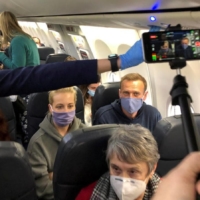 Russian opposition leader Alexei Navalny and his wife, Yulia Navalnaya, on a plane bound for Moscow on Jan. 17.  | REUTERS