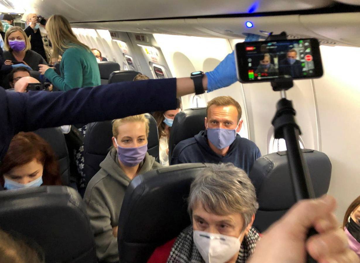 Russian opposition leader Alexei Navalny and his wife, Yulia Navalnaya, on a plane bound for Moscow on Jan. 17. | REUTERS