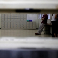 Detainees are seen through a hatch at the Tokyo Detention House in December 2015. | REUTERS