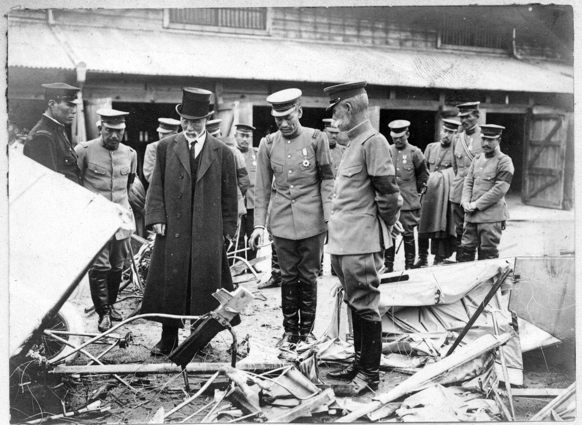 Aikitsu Tanakadate (left) became actively involved in military aviation ahead of World War II, and is seen here with military personnel at the site of an air crash in 1935. | COURTESY OF TANAKADATE AIKITU MEMORIAL SCIENCE MUSEUM