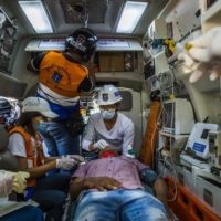 An injured protester receives medical attention in an ambulance after police and military forces cracked down on a protest against the military coup, in Mandalay, Myanmar, on Saturday.  | THE NEW YORK TIMES