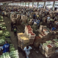 Workers move crates of fresh food at a market and distribution center in Rio de Janeiro in June 2020. | BLOOMBERG