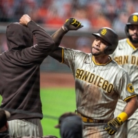 The Padres\' Tommy Pham (right) is congratulated after hitting a two-run home run against the Giants in San Francisco on Sept. 26, 2020. | USA TODAY / VIA REUTERS
