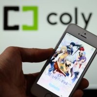 Coly Inc.\'s mobile game Promise of Wizard is played on a smartphone. Coly\'s co-founders Anna and Mizuki Nakajima took their seven-year-old mobile games studio public Friday, and the stock doubled, the strongest market debut of 2021. | BLOOMBERG