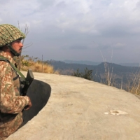 A Pakistani Army soldier stands guard on the Line of Control in the Bhimber district of Pakistani-controlled Kashmir on Feb. 5. | AFP-JIJI