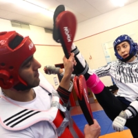 Olympic medalist Kimia Alizadeh lands a kick against her husband and training partner Hamed Madanchi during a practice session in Aschaffenburg, Germany, on Feb. 17. | REUTERS