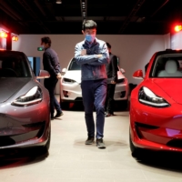 Tesla Model 3 sedans and a Tesla Model X sport utility vehicle are put on display at a Tesla showroom in Shanghai. Model 3 sales are taking off in Japan following a price cut. | REUTERS