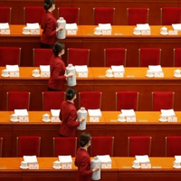 Attendants serve tea before the opening session of the National People\'s Congress at the Great Hall of the People in Beijing on Friday. | REUTERS