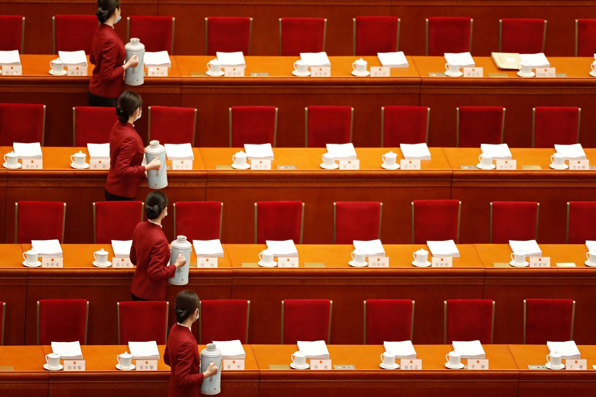 Attendants serve tea before the opening session of the National People's Congress at the Great Hall of the People in Beijing on Friday. | REUTERS