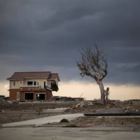 A lone house sits on the scarred landscape inside the exclusion zone close to the devastated Fukushima No. 1 nuclear power plant in February 2016 in Namie, Fukushima Prefecture. | GETTY IMAGES / VIA BLOOMBERG