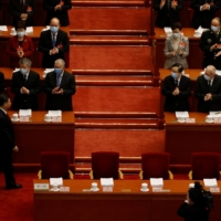 Hong Kong Chief Executive Carrie Lam and other Chinese officials applaud as Chinese President Xi Jinping arrives for the opening session of the National People\'s Congress at the Great Hall of the People in Beijing on Friday. | REUTERS