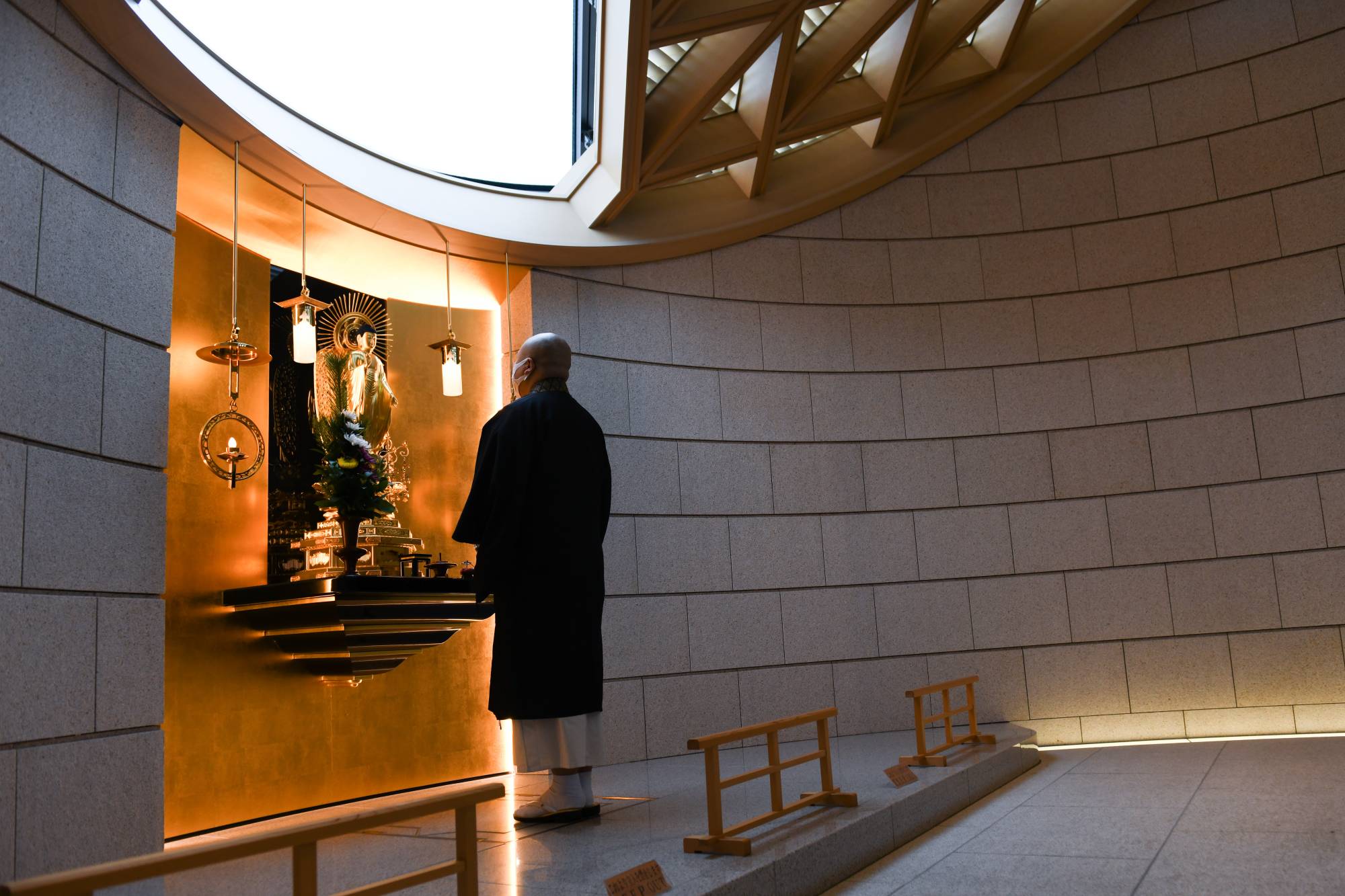 A priest offers a prayer inside a 'common grave' at Tsukiji Hongwanji temple in Tokyo on Feb. 2. | BLOOMBERG