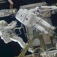 Soichi Noguchi (left) and his colleague are shown on a spacewalk outside the International Space Station on Friday. | NASA / VIA KYODO