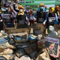 Protesters near a blockade in Yangon, Myanmar, on Saturday during a demonstration against the military coup | AFP-JIJI