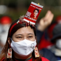 A demonstrator protests against the military coup in Myanmar on February 14 in Tokyo.  | REUTERS 