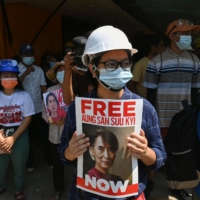 A protester holds a sign calling for the release of detained Myanmar civilian leader Aung San Suu Kyi during a demonstration against the military coup in Yangon on Sunday.  | AFP-JIJI