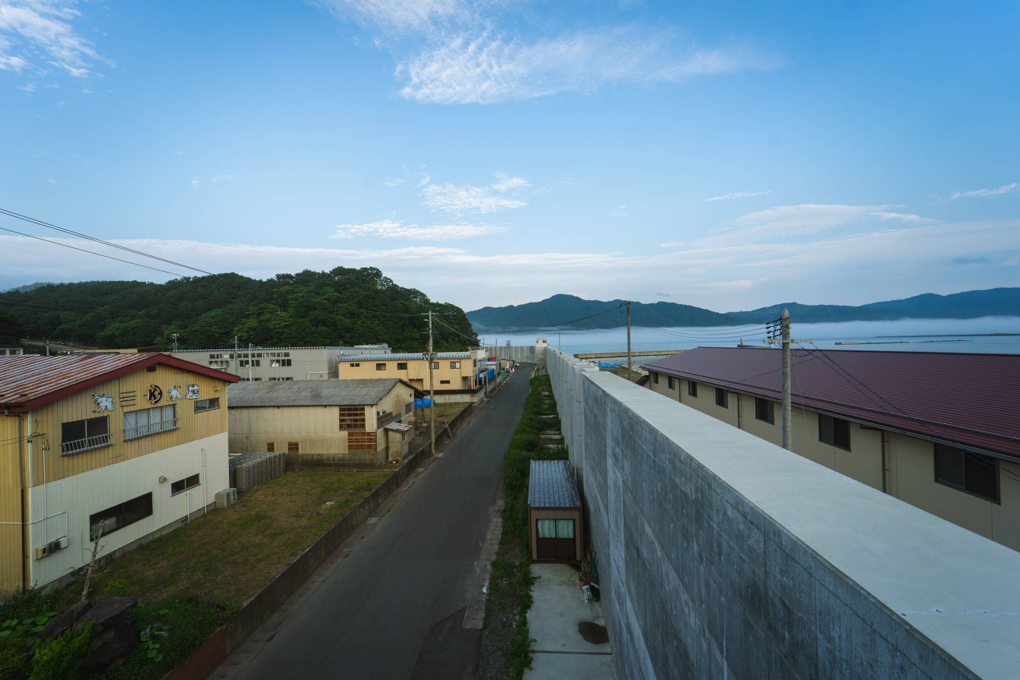 The seawall in Miyako, Iwate Prefecture, is the same height as the warehouses that serve the port. | OSCAR BOYD