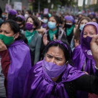 Women demonstrate to demand rights and gender equality during an International Women\'s Day rally in Bogota on Monday. | BLOOMBERG 