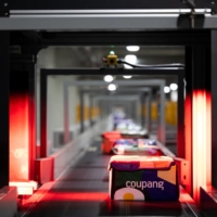Eco-bags carrying fresh food are laser scanned as they travel along a conveyor belt at a Coupang Corp. fulfillment center in Bucheon, South Korea, in February. South Korean e-commerce giant Coupang filed for an initial public offering in the U.S. and that could raise billions of dollars to battle rivals and kick off a record year for IPOs in the Asian country. | BLOOMBERG