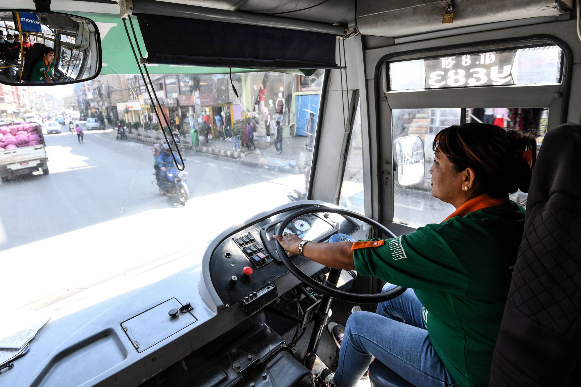 As part of moves to make public transport greener, women have been driving hundreds of electric three-wheeled, 12-seater buses for the past 25 years in Kathmandu. | AFP-JIJI