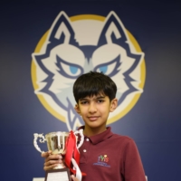 Yugen Padhye, an 11-year-old student at Tokyo YMCA International School, holds a trophy after winning the Japan Spelling Bee on March 6. | STS PHOTOGRAPHY
