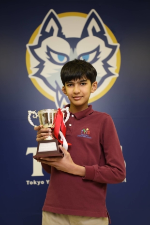 Yugen Padhye, an 11-year-old student at Tokyo YMCA International School, holds a trophy after winning the Japan Spelling Bee on March 6. | STS PHOTOGRAPHY 