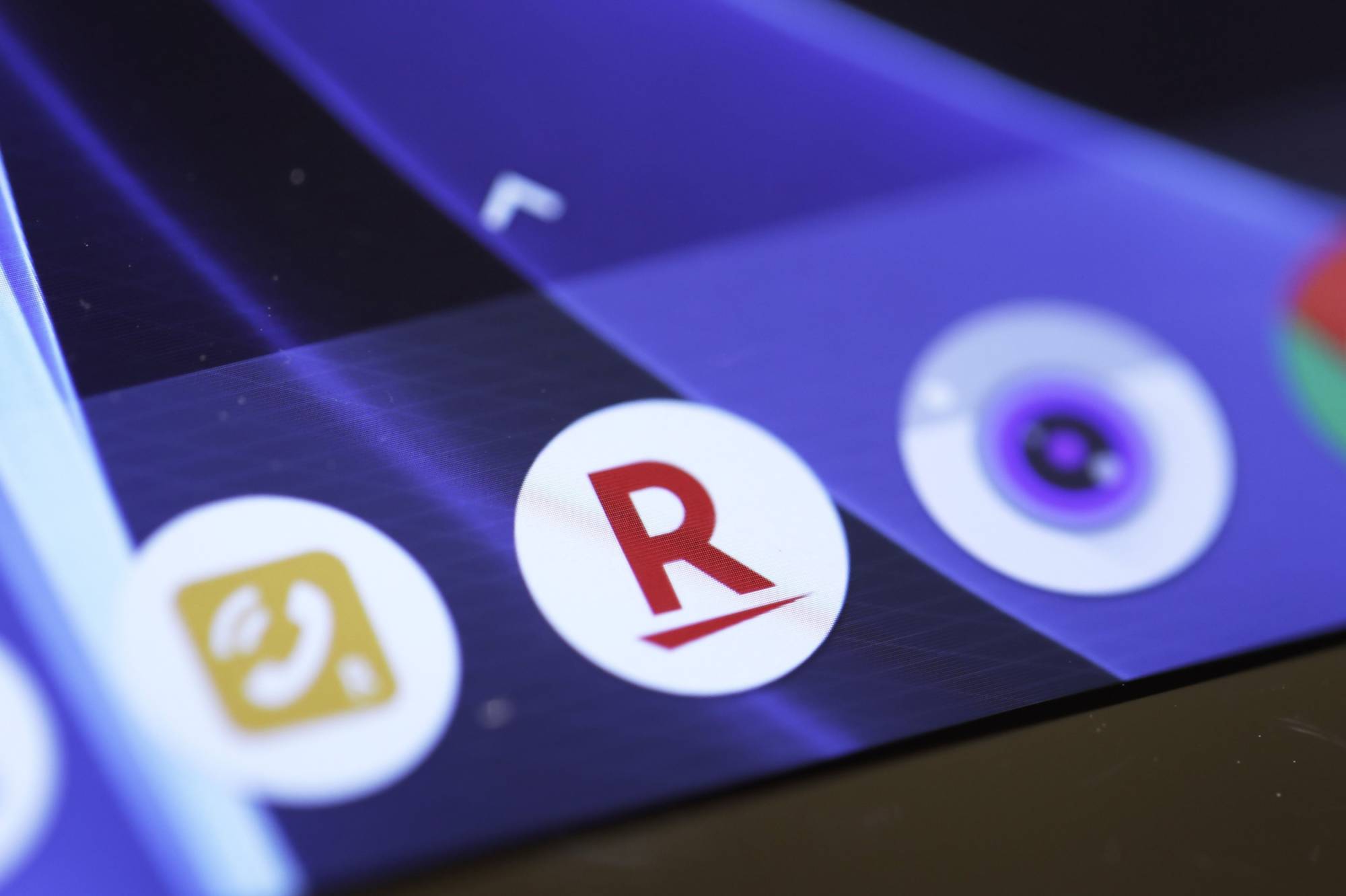 The icon for the Rakuten Inc. e-commerce store app is displayed on a smartphone inside the company's cafe in Tokyo in January 2019. | BLOOMBERG