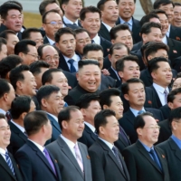 North Korean leader Kim Jong Un poses for a photo with military chief executive secretaries in Pyongyang in this undated photo released March 7. | KCNA / VIA REUTERS
