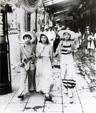 Stylish stroll: Young 'moga' (modern girls) walk down a street in Tokyo's Ginza district in 1928. | KAGEYAMA KOYO