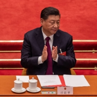 Chinese President Xi Jinping applauds after a vote on changes to Hong Kong\'s election system during the closing session of the National People\'s Congress at the Great Hall of the People in Beijing on Thursday.  | AFP-JIJI
