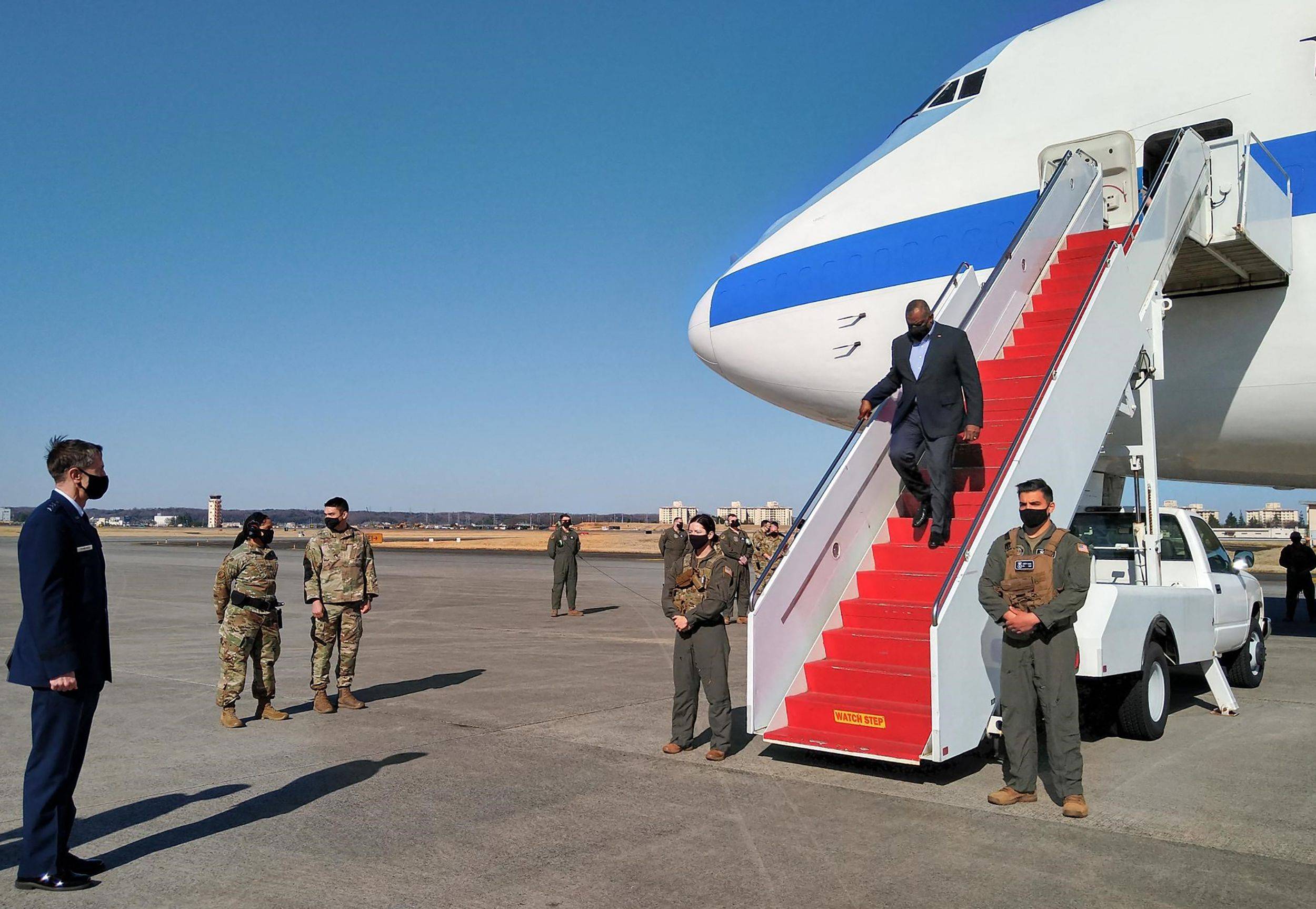 U.S. Defense Secretary Lloyd Austin disembarks from a plane upon his arrival at the Yokota Air Base in Tokyo on Monday. | AFP-JIJI