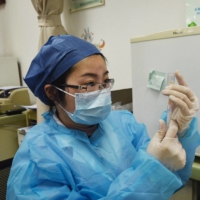 A medical worker prepares to administer a Sinovac Biotech COVID-19 vaccine at a community vaccination center in Hangzhou, in eastern China\'s Zhejiang province, on Monday.  | AFP-JIJI
