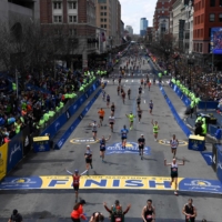 Runners approach the finish line on Boylston Street during the 123rd Boston Marathon in Boston on April 15, 2019. | BLOOMBERG