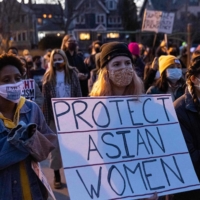 A woman holds a sign during a march against anti-Asian hate on Thursday in Minneapolis.  | AFP-JIJI