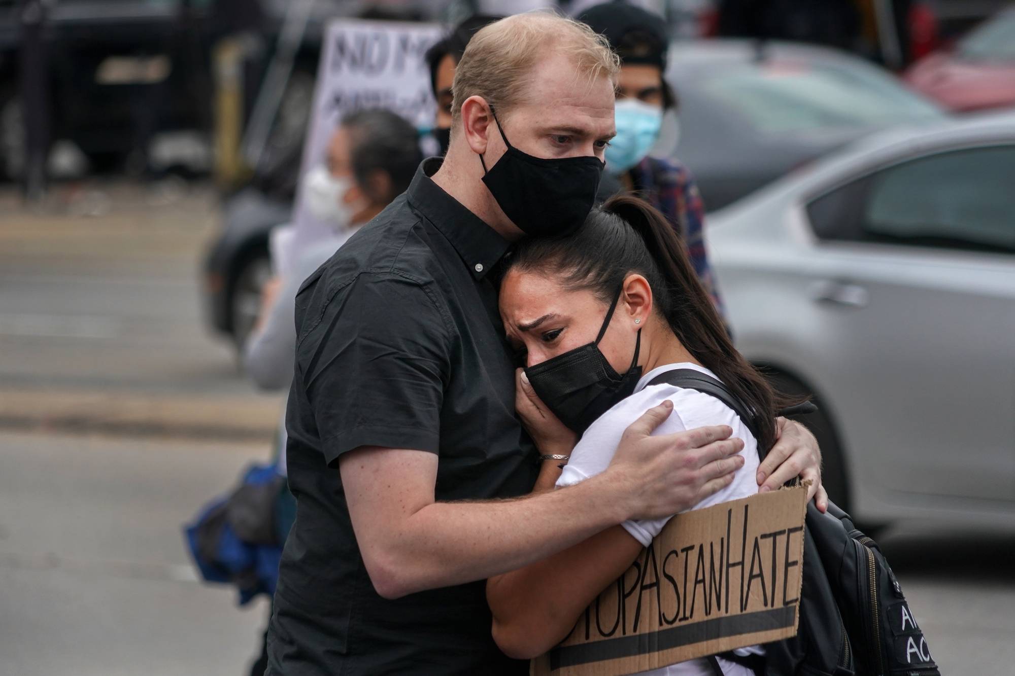 Demonstrators embrace during a rally Thursday calling attention to the rise in violence against Asian Americans, outside Gold Spa near Acworth, Georgia, one of three establishments targeted in a mass shooting earlier this week. | Chang W. Lee / The New York Times