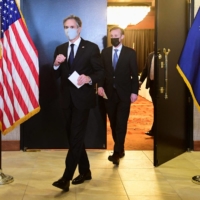 U.S. Secretary of State Antony Blinken and national security adviser Jake Sullivan exit the ballroom used for a closed-door morning session of talks between the United States and China after the conclusion of their two days of meetings in Anchorage, Alaska, on Friday.  | POOL / VIA AFP-JIJI