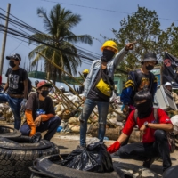 Protesters gather at a makeshift barricade ahead of a crackdown by security forces in the Thaketa township of Yangon, Myanmar, on Saturday. | THE NEW YORK TIMES